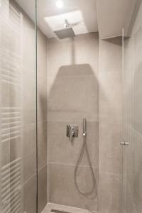 a bathroom with a shower with a glass door at Downtown Urban Luxurious Apartment in Athens