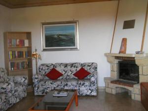 a living room with a couch and a fireplace at Ferienwohnung für 6 Personen in Catignano, Abruzzen in Catignano