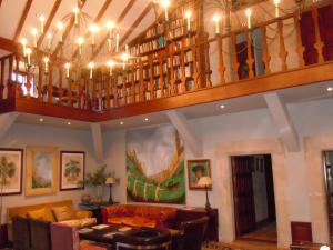 a living room with a couch and a chandelier at Palacio Chaves Hotel in Trujillo