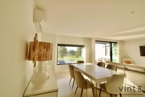 a living room with a table and chairs and a couch at Casa do Golfe by VinteOito in Amarante