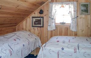um quarto com 2 camas num chalé de madeira em Stunning Home In Kolbjrnsvik With Kitchen 