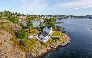 an aerial view of a house on a rocky island in the water at Beautiful Home In Kolbjrnsvik With 2 Bedrooms And Wifi 