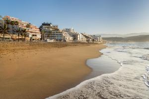a view of a beach with buildings and the ocean at Occidental Las Canteras in Las Palmas de Gran Canaria