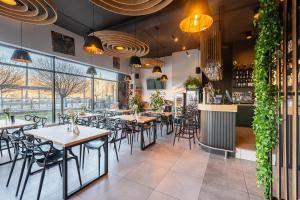 a restaurant with tables and chairs and a bar at City Break Wolska Aparthotel in Warsaw