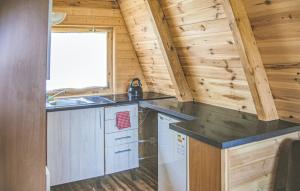 a kitchen in a tiny house with a sink at 1 Bedroom Lovely Home In Mielno in Mielno