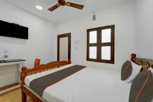 a bedroom with a large bed and a window at Collection O CHITRA LODGE 