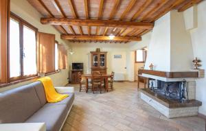 Una sala de estar con un sofá y una chimenea. en Pet Friendly Home In Montebuono, en Agello