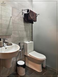 a bathroom with a toilet and a sink at Karvan Hotel Naftalan in Naftalan