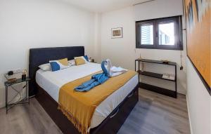 a bedroom with a bed with a blanket on it at Awesome Apartment In Málaga With Wifi in Málaga