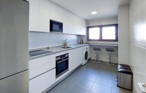 a white kitchen with a sink and a dishwasher at Awesome Apartment In Málaga With Wifi in Málaga