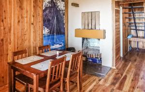 a dining room with a wooden table and chairs at Amazing Home In Mielno With Kitchen in Mielno