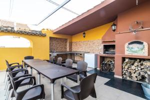 a dining room with a table and chairs and a fireplace at Casa Rural La Loma in Granada