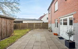 a patio in a yard next to a brick building at Gorgeous Home In Sby r With Wifi in Søby