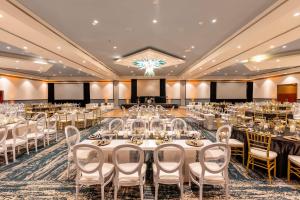 a banquet hall with white tables and chairs at Hilton Aruba Caribbean Resort & Casino in Palm-Eagle Beach +138 photos