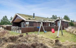 a house with two swings in front of it at Amazing Home In Rm With Wifi in Bolilmark