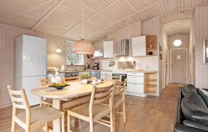 a kitchen with a table and chairs and a refrigerator at Amazing Home In Rm With Wifi in Bolilmark