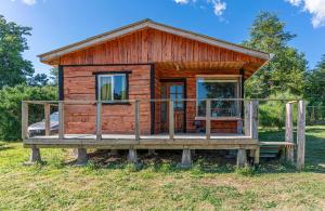 a log cabin with a porch on a platform at Cabañas Estrella del Sur in Puerto Varas