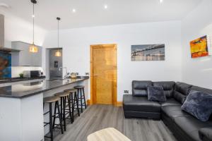 a living room with a couch and a kitchen at The Residence At The Lawrence Apartments in York