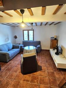 a living room with a couch and a table at Casa el Mirador de Moratalla in Moratalla