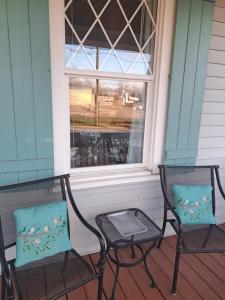 two chairs sitting on a porch with a window at Piano Room Studio with full kitchen and no fees in Florence