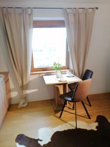 a room with a table and a chair and a window at Haus Miriam in Mieming