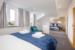 a bedroom with two beds and a mirror at The Hideaway At The Lawrence Apartments in York