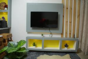a living room with a tv on a wall at Enn lovely apartment 10 in Bungoma