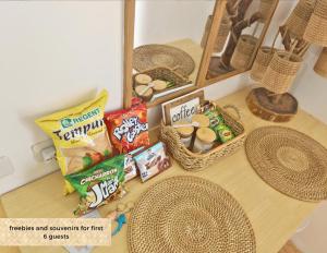 a table with snacks and other foods on it at The Traveller's Haven Airbnb in Cebu City