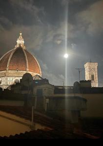 a building with a dome and a clock tower at Appartamento Duomo in Florence