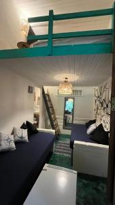 a room with two bunk beds and a staircase at Mar & Ilha - Guest House - Praia de Maresias in São Sebastião