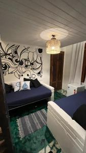 a living room with a bed and a chandelier at Mar & Ilha - Guest House - Praia de Maresias in São Sebastião