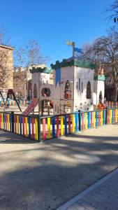 a playground with a colorful fence in front of a building at CASA VACACIONAL INDIVIDUAL 65mtr in Pinto