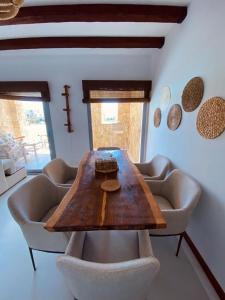 a dining room with a wooden table and chairs at Swan Lake Crystal Lagoon View Chalet in Hurghada