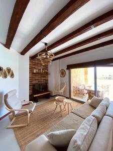 a living room with a large couch and chairs at Swan Lake Crystal Lagoon View Chalet in Hurghada