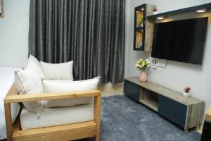 a living room with a flat screen tv on a wall at Enn lovely apartment 11 in Bungoma