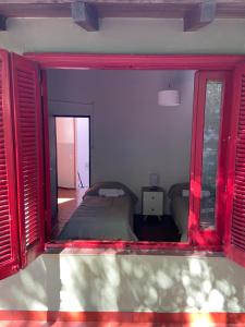 um quarto com uma cama e janelas com persianas vermelhas em La casona de Palermo Hostel Boutique em Buenos Aires