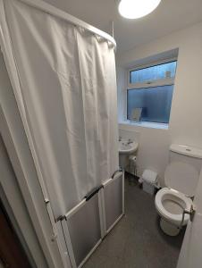 uma casa de banho com um chuveiro, um WC e um lavatório. em Anstuns LODGE em Liverpool