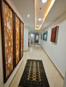 a hallway with a rug on the floor at Gold crest Mall, The Aesthetic one bed suite in Lahore