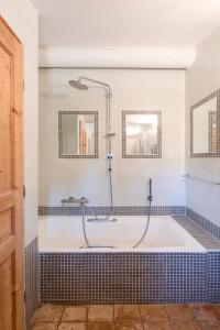 a bathroom with a bath tub with a shower at La Bastide des Milles in Apt