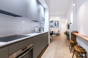 a kitchen with white cabinets and a counter top at New Luxury flat next to Gran Vía in Madrid