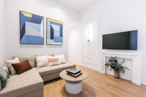 a living room with a couch and a tv at New Luxury flat next to Gran Vía in Madrid