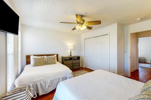 a bedroom with two beds and a ceiling fan at The Red Rocker in Highland View