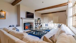 a living room with a white couch and a fireplace at Foxholme Manor in Broadway