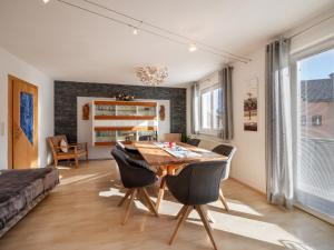 a dining room with a wooden table and chairs at Exklusiv Apartment Hofer in Sankt Johann in Tirol +34 photos