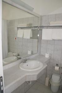 a bathroom with a sink and a toilet and a mirror at Faliraki Dream Apartment 1 in Kallithea Rhodes