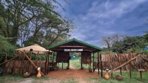 a shed with a sign that reads this guest only at Talek Bush Camp , Masai Mara in Talek