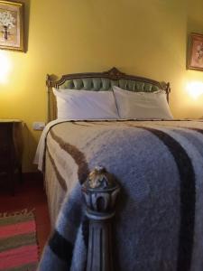 a bedroom with a large bed with a blue blanket at La Sala Hotel Boutique in Tinogasta