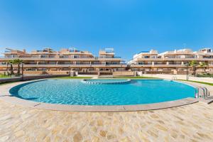 a large swimming pool in front of a building at Palace Torre de la Horadada in Torre de la Horadada