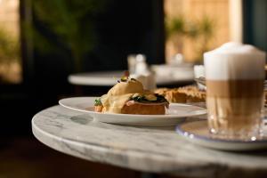 a table with two plates of food and a cup of coffee at Sant Jaume Design Hotel in Palma de Mallorca