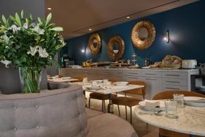 a dining room with tables and chairs and mirrors at Sant Jaume Design Hotel in Palma de Mallorca